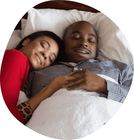 Man and woman sleeping soundly after oral appliance therapy in Frisco