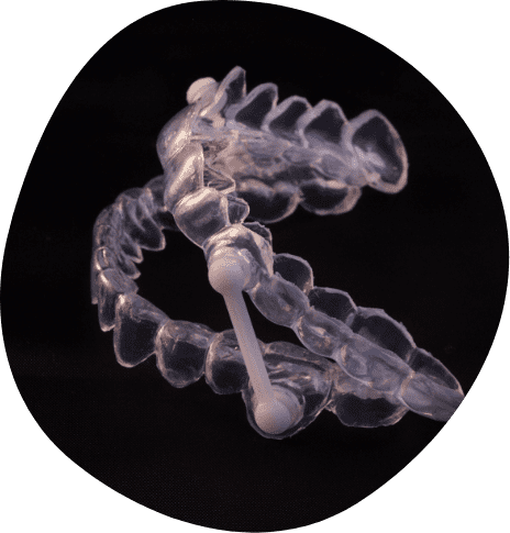 Clear oral appliance against black background