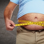 man measuring stomach