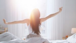 woman stretching and waking up