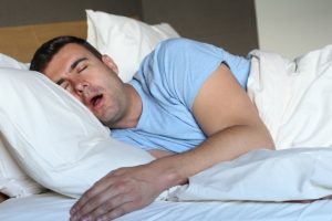 man snoring in bed