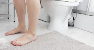 woman's legs next to the toilet