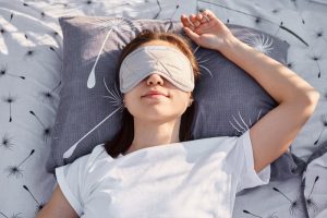 woman trying to sleep with a eye mask on