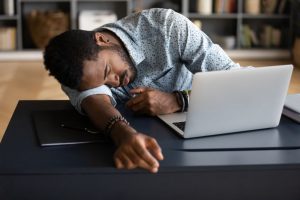 man sleeping at work from narcolepsy