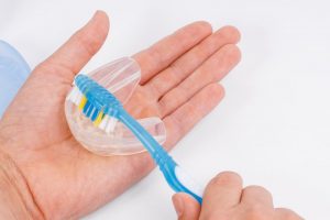toothbrush cleaning an oral appliance