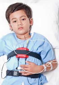 little boy with sleep study equipment on him