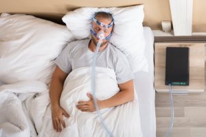 man sleeping with CPAP