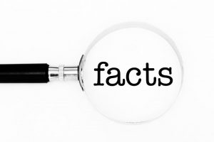magnifying glass with the word facts