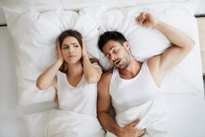 fit man snoring with his partner