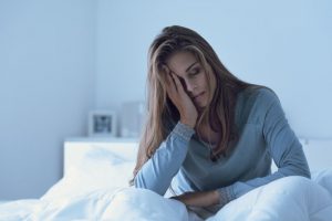 woman struggling with insomnia in bed